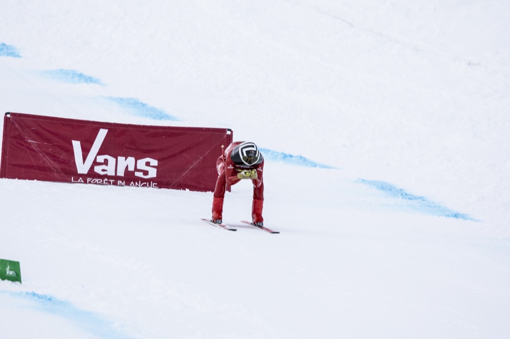 Jan Farrell in a tuck passing the Vars finish banner